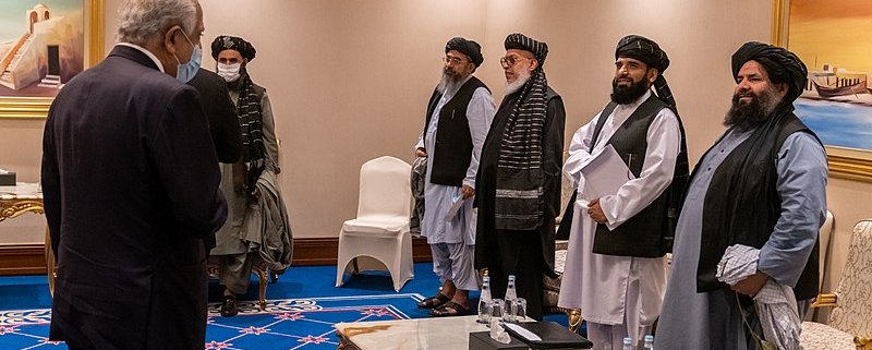 Taliban negotiators in Doha, Qatar, November 2020. On the left, wearing a gray suit and white mask, is Abdul Ghani Baradar, current abinet leader in Kabul. Photo: Ron Przysucha, U.S. Department of State, Public Domain