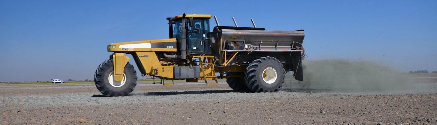 A spreader unloads crushed metabasalt rock on a fallowed corn field in the Central Valley. Photo: Amy Quinton/ UC Davis, for media use